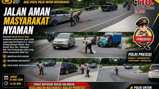 Personel Polsek Pancur Batu Sigap Antisipasi Jalan Licin di Tikungan Rehab Sibolangit.